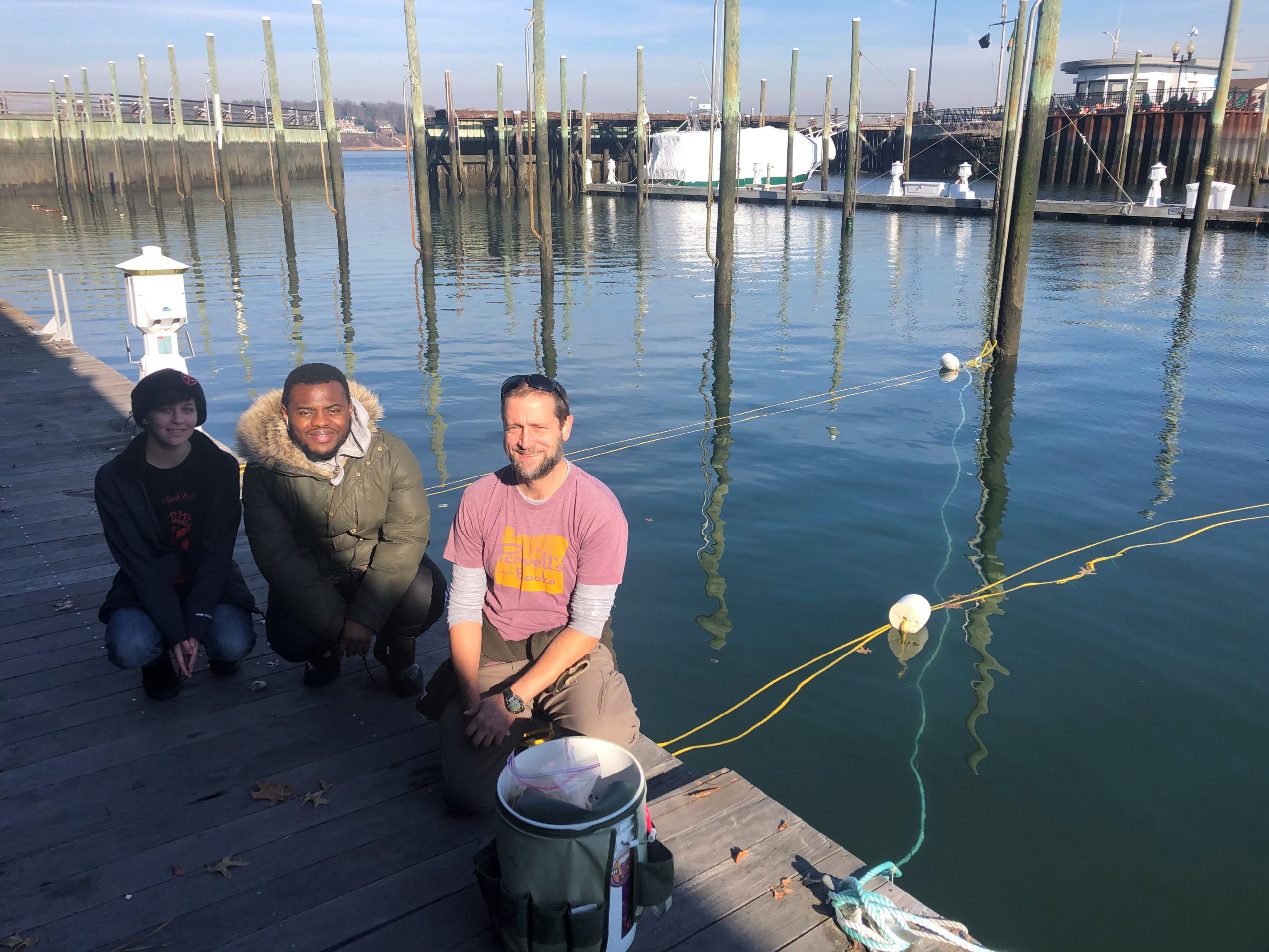 Dr. Aaren Freeman, a marine scientist at Adelphi University (right), and Adelphi students Amanda Hornung and Thierno Diallo pose for a picture after a day of seeding long lines with juvenile kelp seed. Photo courtesy of Dave Gugerty.
