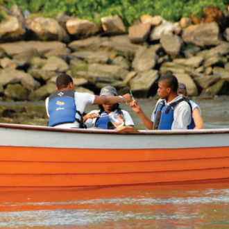 Photo of youth on a Rocking the Boat boat. Photo courtesy of Rocking the Boat