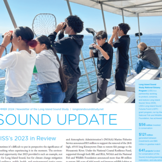 Cover page of the Sound Update newsletter, which includes an image of students looking out to the water with binoculars.