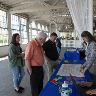 People looking at a table with information.