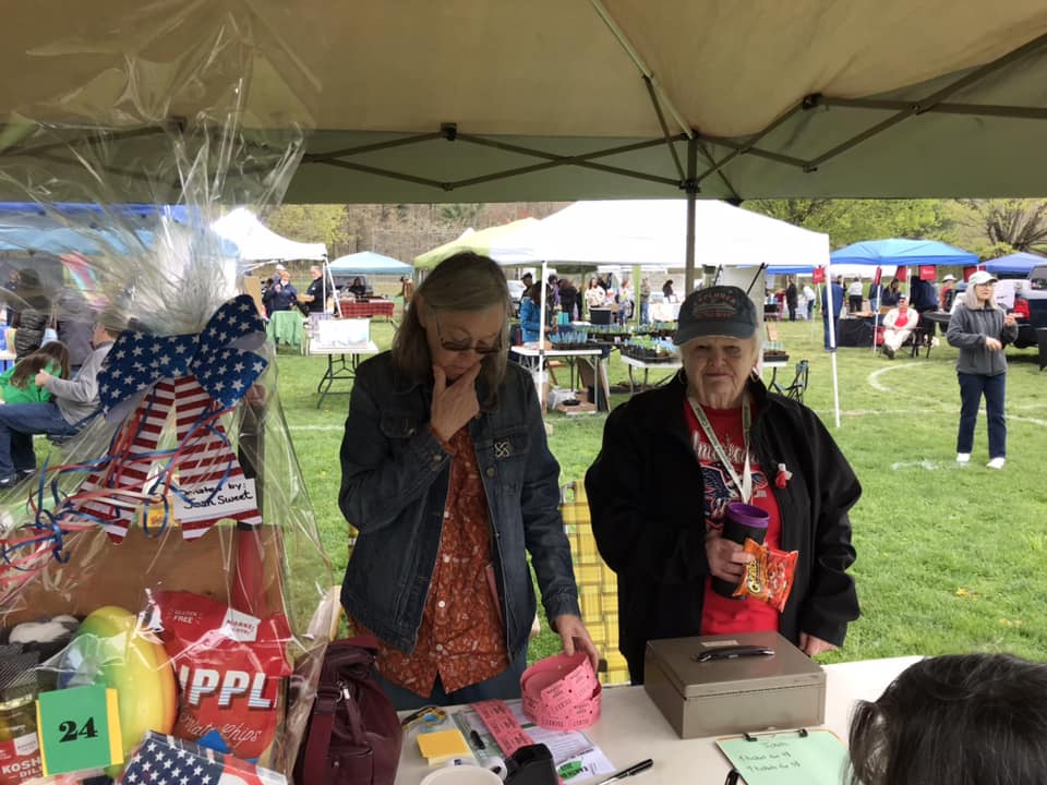 Two women at a fair tabling.