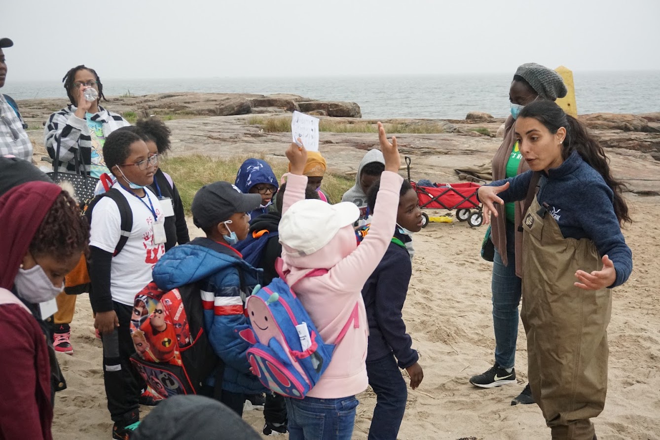 NYSG staff member and LIS Partnership Outreach Specialist Lilli Genovesi  engages elementary school students from the Bronx Children's Museum during a Sound Stewards field trip at Orchard Beach in Pelham Bay Park. Students explored the Long Island Sound estuary, collected water quality data aligned with the Unified Water Study (pH, turbidity, salinity, dissolved oxygen, nitrate and temperature), and identified marine life using a seine net—gaining hands-on experience in science, stewardship, and conservation.